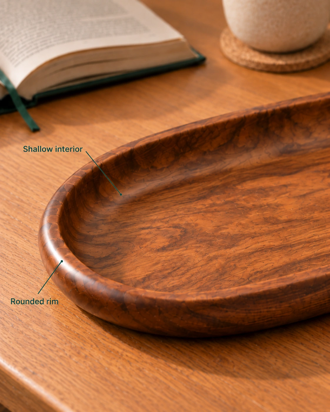 Close view of an empty oval wooden tray, with labels identifying its rounded rim and shallow interior.